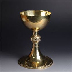 Mid 20th century silver-gilt chalice, the goblet with hammered finish upon knopped stem, the knop embossed with symbols and foliate decoration, engraved to base ' veni non ministrari sed ministrare' and with presentation engraving to underside, hallmarked Guild of Handicraft, London 1957, H17cm