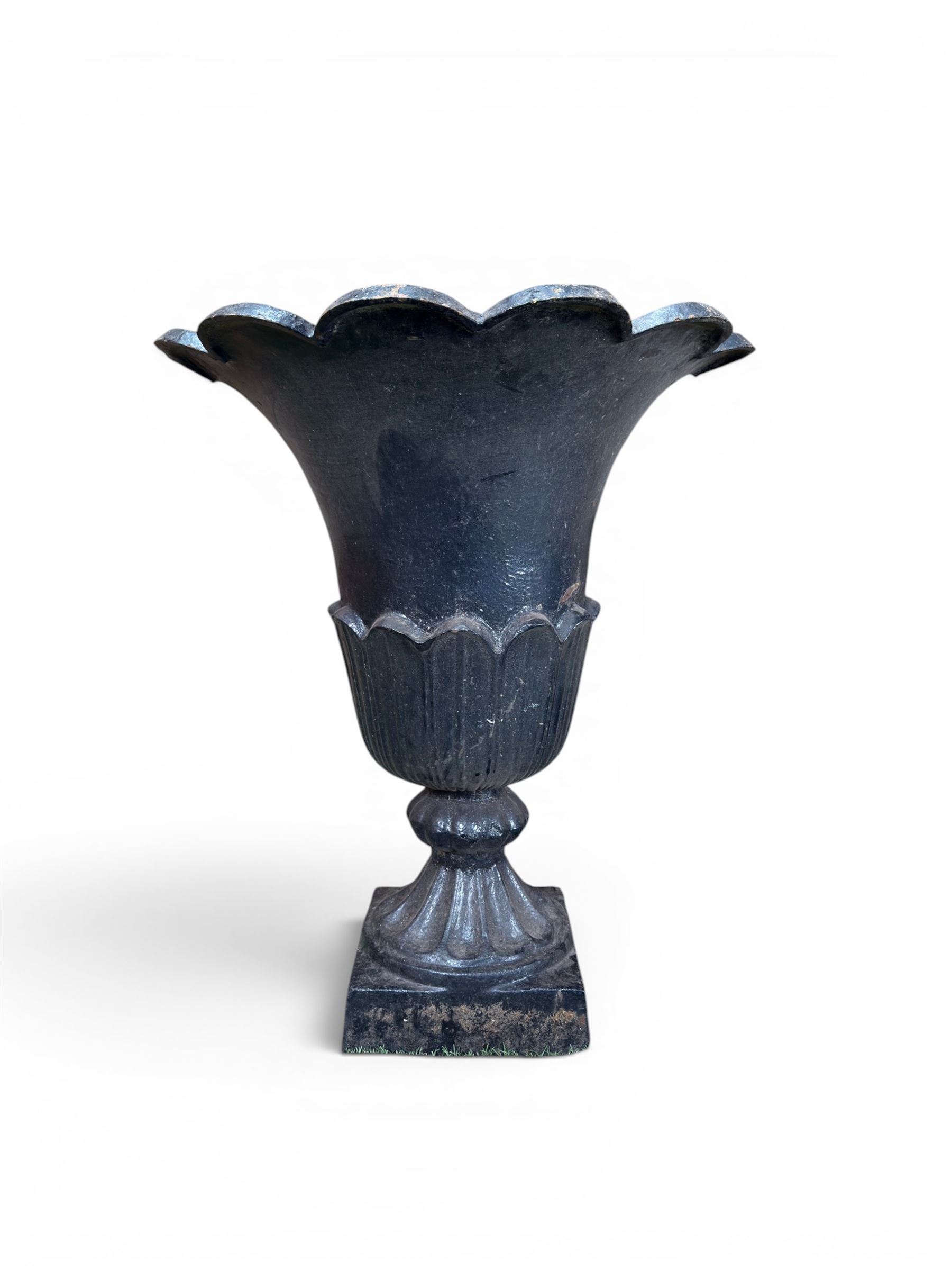 Pair of Victorian large scale cast iron garden urns, flared petal shaped rim with tapering waist, gadrooned base on square plinth, finished in black paint