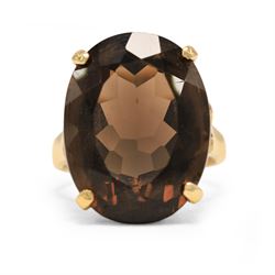 14ct gold smokey quartz ring, four claw set with a single oval cut quartz, stamped