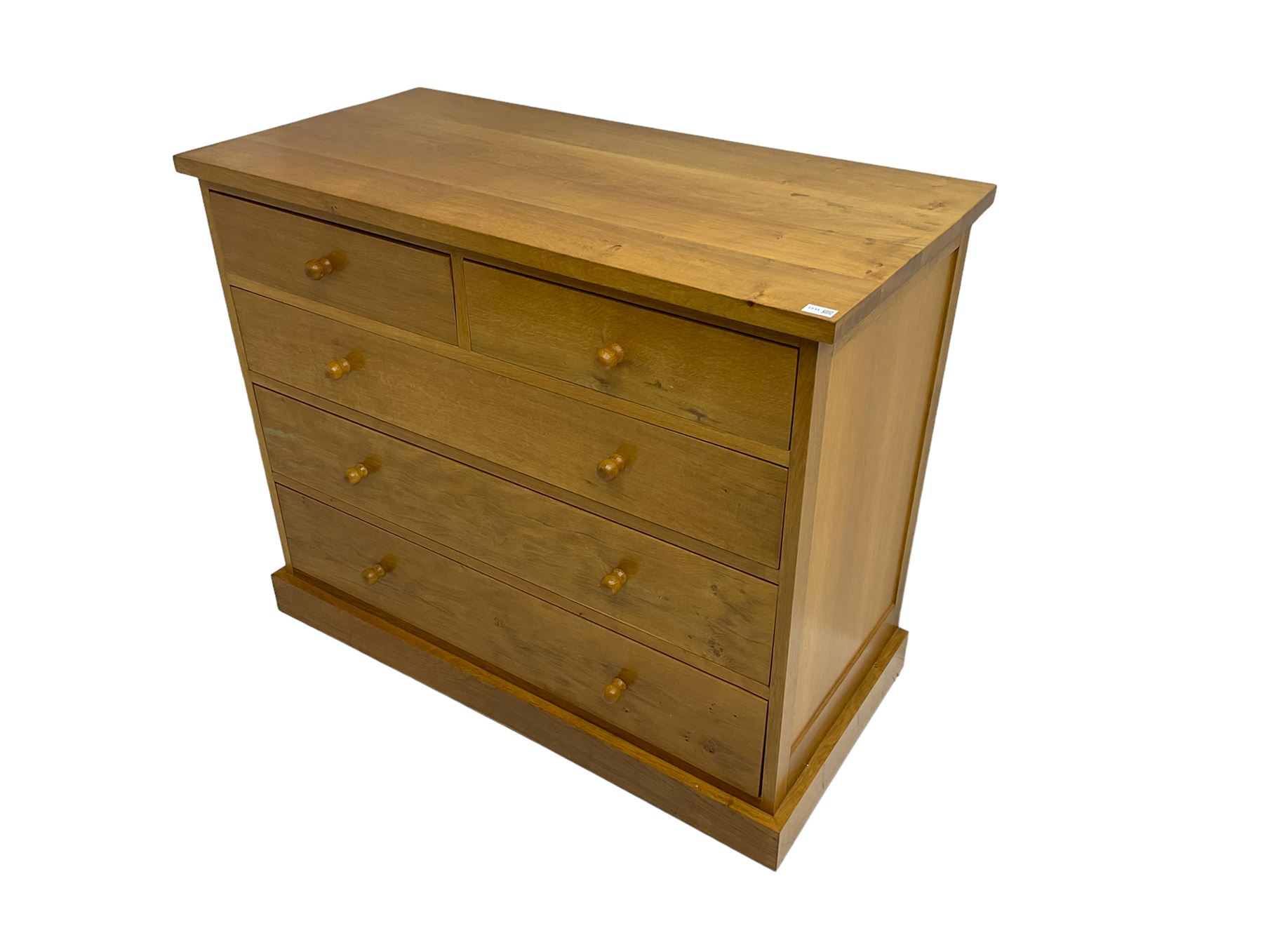 Craftsman made light oak chest, fitted with two short and three long drawers, on plinth base