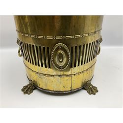 Victorian brass coal bin, the body of cylindrical form with pierced gallery between bead and dart borders, interspersed with patera and two lion mask ring handles, the tapering cover with ring handle lifting to reveal a steel liner, the whole upon four pad feet, H47cm 