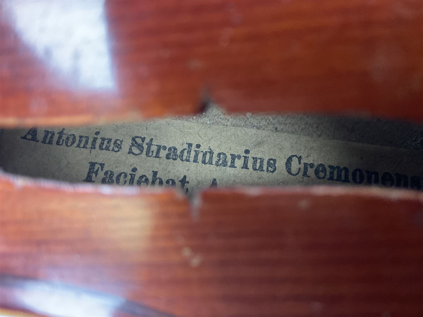 Late 19th century French three-quarter size 'Conservatory' violin with 34cm two-piece maple back and ribs and spruce top, the peg box inscribed 'Conservatory Violin Straduari', bears label 'Antonius Stradiuarius Cremonensis Faciebat Anno 1721' L55.5cm overall; in ebonised wooden 'coffin' case; and Saxony violin c1900 with 36cm two-piece maple back and ribs and spruce top; bears label 'Antonius Stradivarius Cremonensis Faciebat Anno 17**' L59cm overall; in carrying case (2)