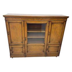 Late Victorian pollard oak bookcase or sideboard, the central glazed door opening to reveal adjustable shelves and interior makers label 