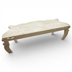 French style low console table, the shaped rectangular top with undulating outline and moulded edge, worn painted finish throughout, the frieze carved with flowing C-scrolls, shell and foliate detail centred by a floral reserve, on cabriole legs with carved knees and inward curving feet