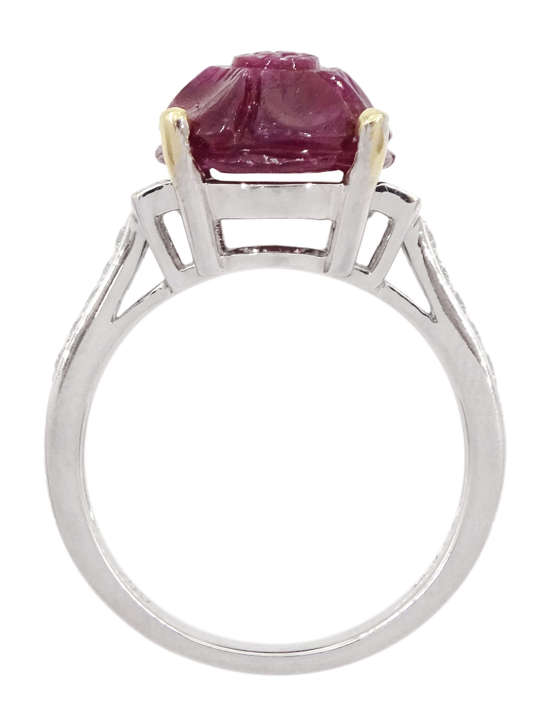 18ct white gold carved ruby ring, set with two baguette cut diamonds either side and diamond set shoulders, ruby approx 6.00 carat