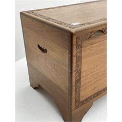 Late 20th Century camphor wood chest, single hinged lid with carved foliage detailing, ogee bracket supports