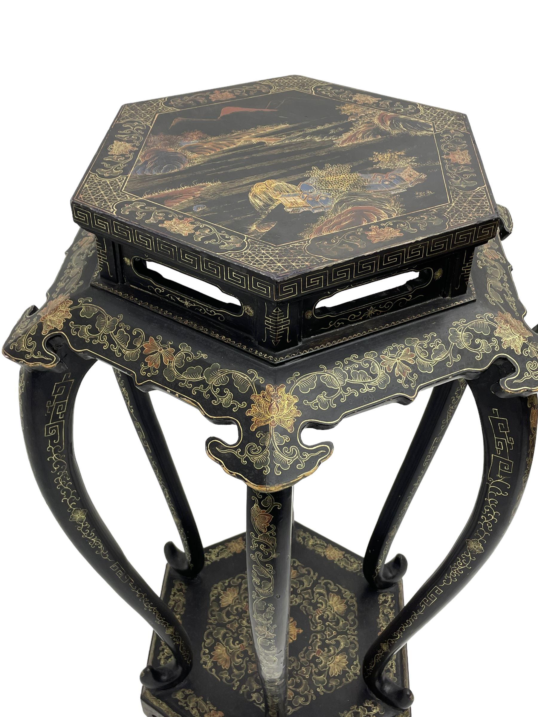 Chinese black lacquer jardinière stand, the hexagonal top painted with traditional landscape scenes within a gilt strung border, the pierced frieze with trailing foliate decoration and geometric patterns, supported on six cabriole supports united by a raised hexagonal base