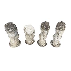Four weathered cast stone lions in seated poses