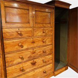 Victorian satinwood reverse breakfront triple wardrobe, projecting moulded cornice over twin full-length panelled cupboard doors flanking central linen press section, fitted with two cupboard doors above two short and four long drawers, turned wooden handles and moulded plinth base
