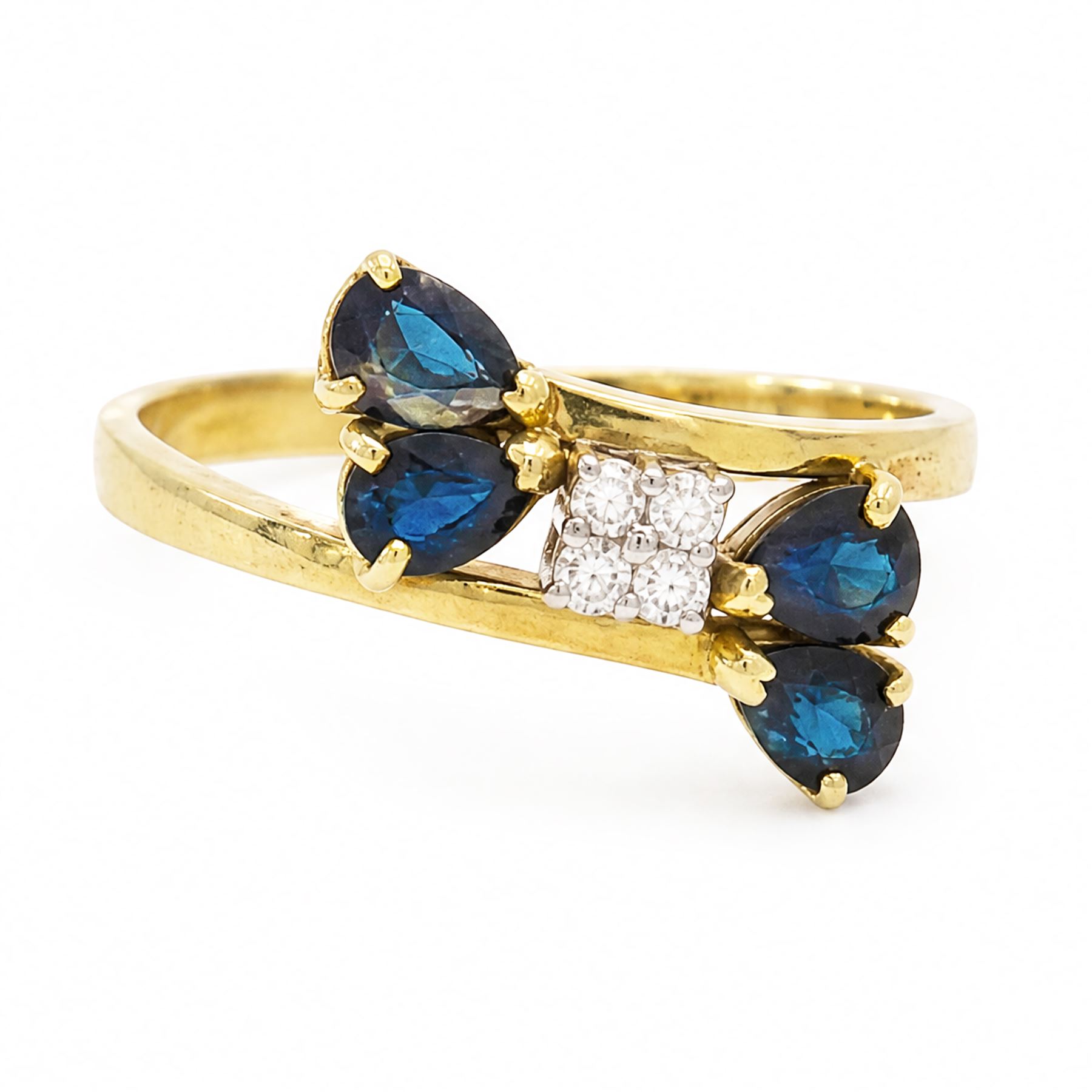 18ct gold sapphire and diamond crossover ring, four round brilliant cut diamonds, each finial set with two pear cut sapphires, London 1978