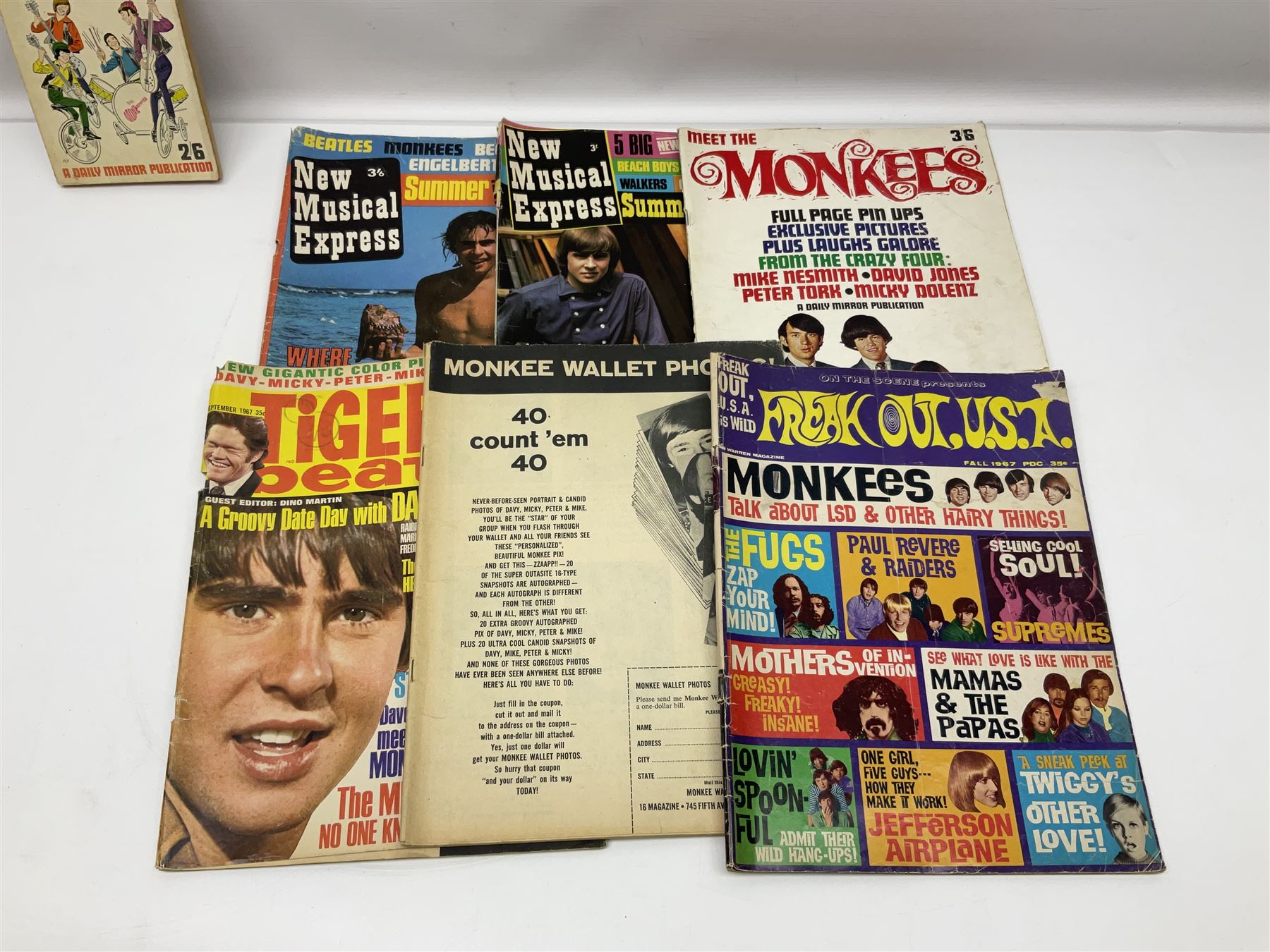 Monkees memorabilia - 'Monkees Monthly' magazine almost complete run from No.1 Feb 67 to No.31 Aug 69 (lacking nos.29 and 32); the cover of No.1 signed by all four members of the group during their 1997 Reunion Tour; quantity of A&BC bubble gum cards; programme for their only UK live performance in 1967 at Empire Pool Wembley; and other related late 1960s music magazines/paperback book