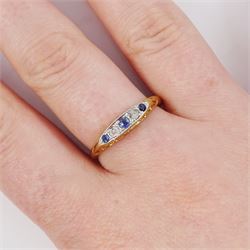 Early 20th century 18ct gold sapphire and diamond five stone ring, set with three round cut sapphires and two old cut diamonds and scroll engraved gallery 
