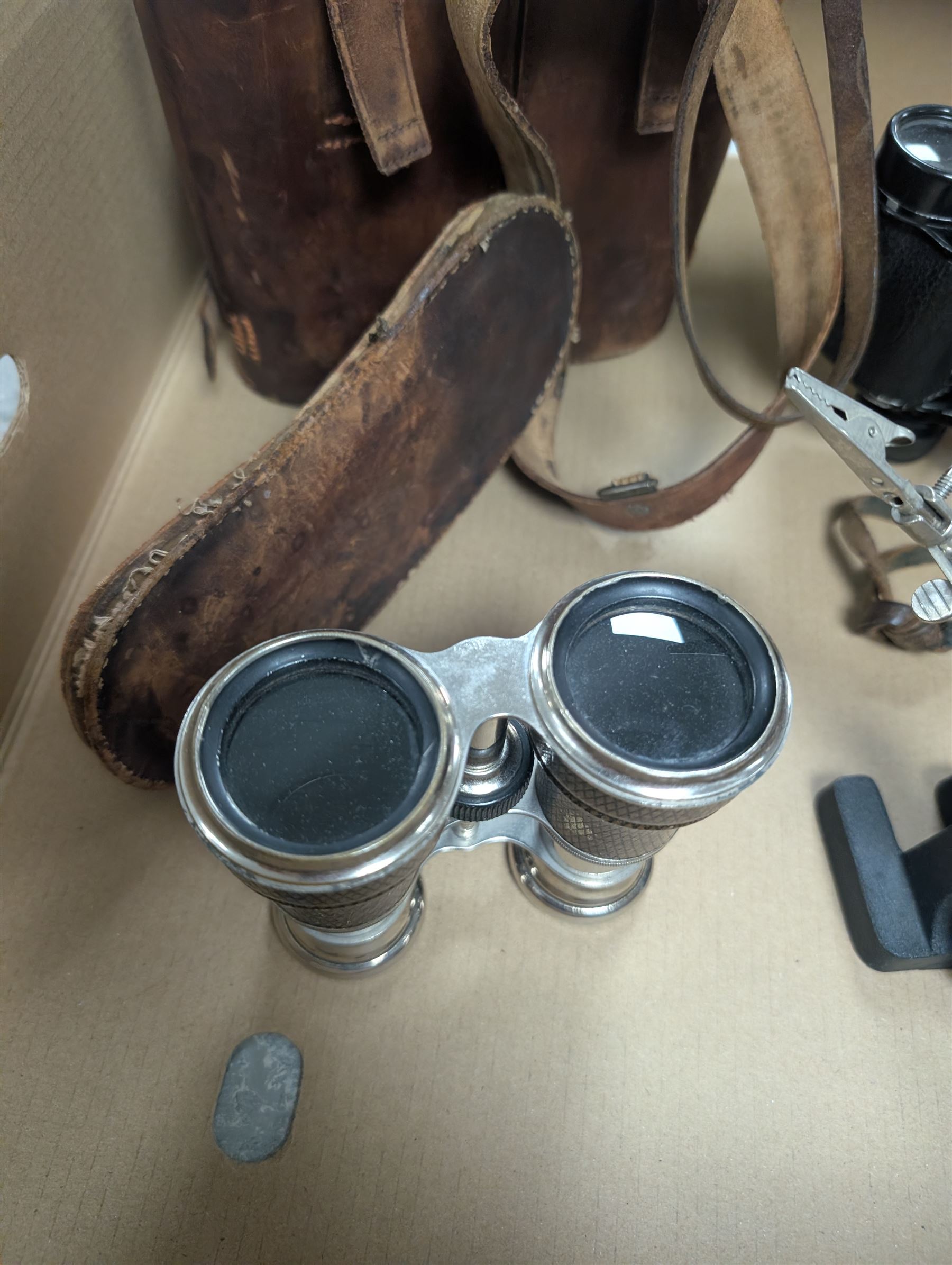 Three pairs of binoculars including Wrayvu 8x30 and Busch Hellux, together with a tabletop magnifying glass