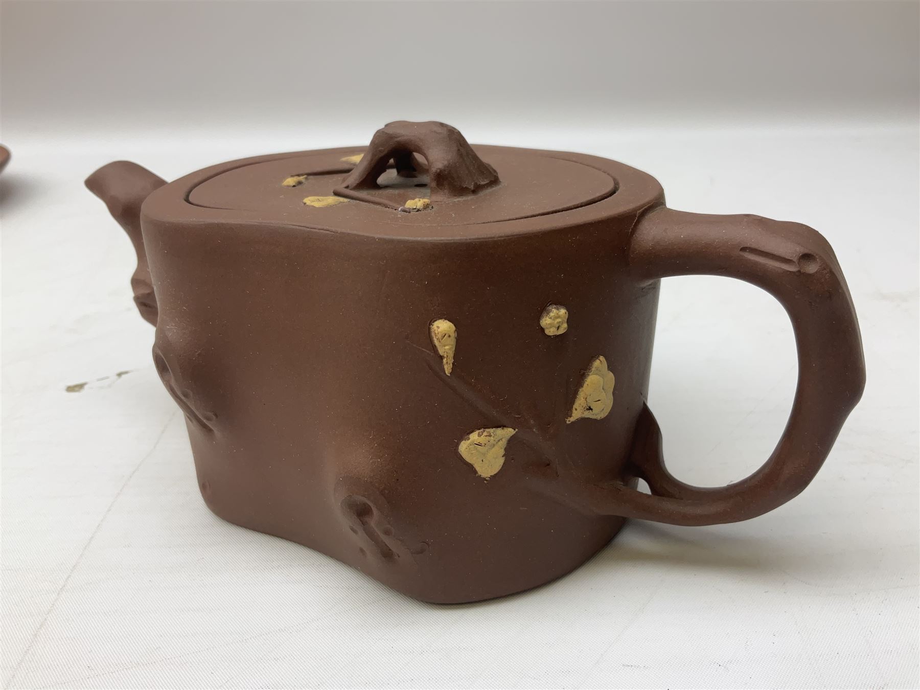 Three Chinese Yixing clay teapots, the first example with marbled