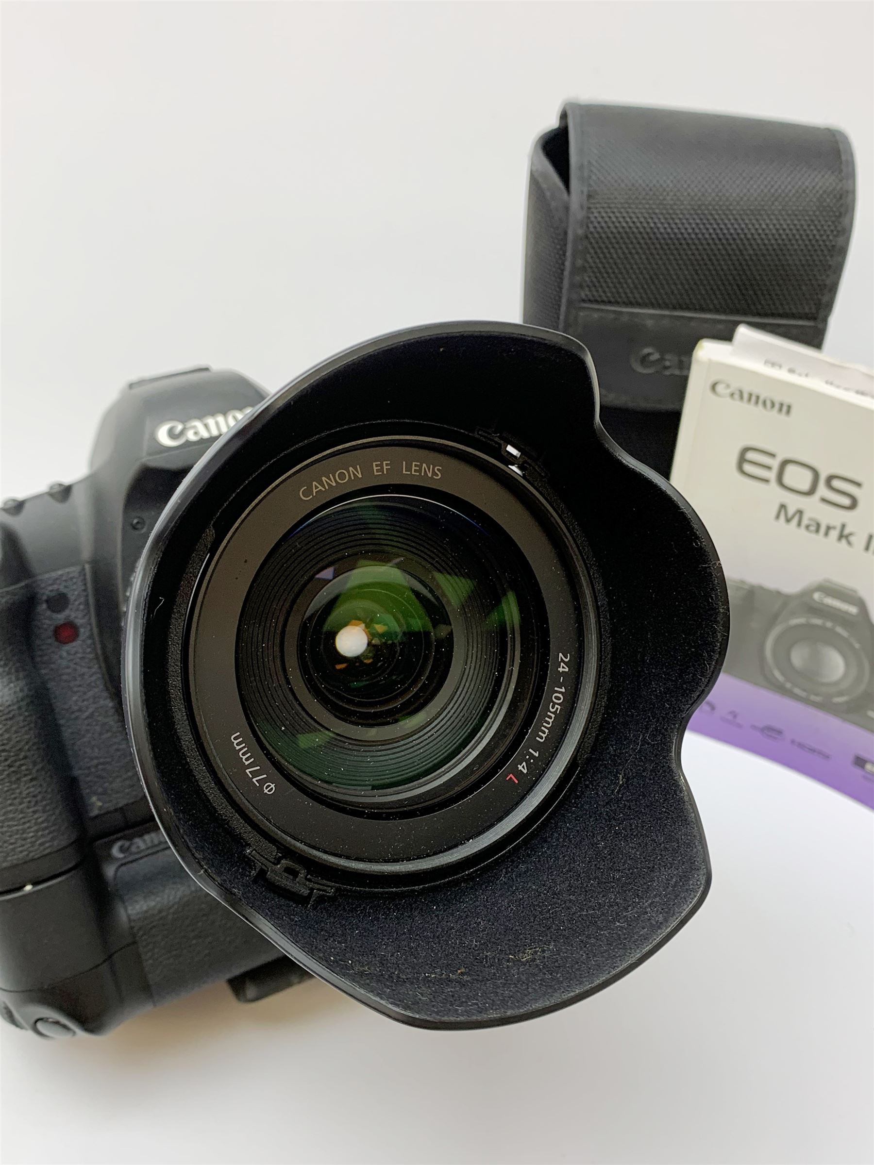 Canon EOS 5D camera body with Canon 'BG-E6' battery grip, Canon 'Speedlite 580EXII' flash and Canon lens 'Canon Zoom Lens EF 24-105mm 1:4 L IS USM' with Canon EOS 5D Mark II instruction manual