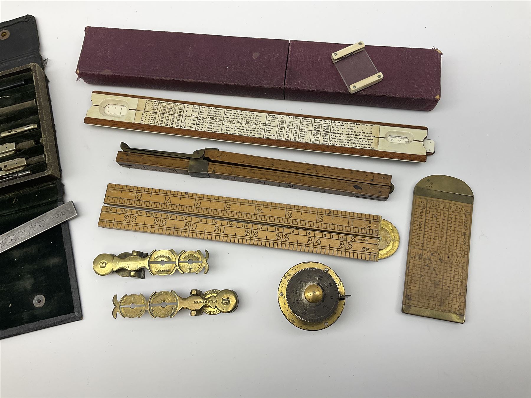Two Victorian brass sovereign scales, one marked 'Harrison' L10cm; cased set of drawing instruments by G. Thornton Limited Manchester; Chesterman No.770/1 steel vernier caliper; two boxwood rulers; cased slide rule; brass and boxwood rope/wire gauge etc