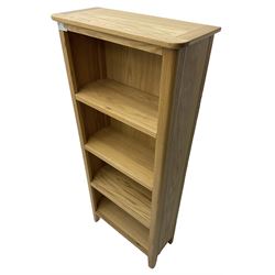 Contemporary light oak open bookcase, fitted with three shelves, on tapering supports