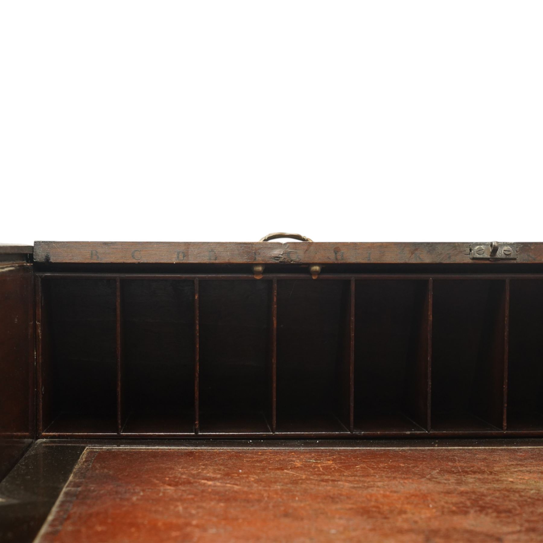 Late 18th century George III mahogany Chippendale design cylindrical roll-top desk carved profusely with geometric and foliate blind-fretwork throughout, the tambour-roll top opening to reveal pigeon holes over an inset red leather writing surface, fitted with two frieze drawers below, raised on square supports with inner chamfer terminating to brass castors, circa 1780s