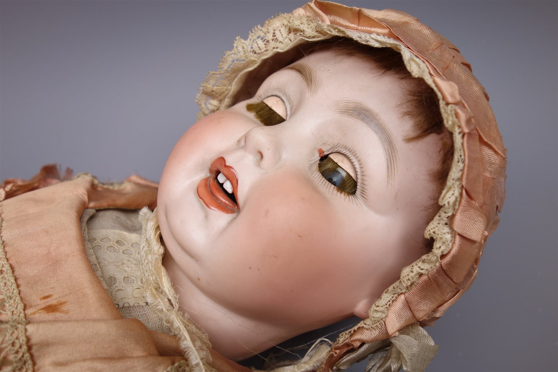 German bisque head doll with applied hair, sleeping eyes, open mouth
