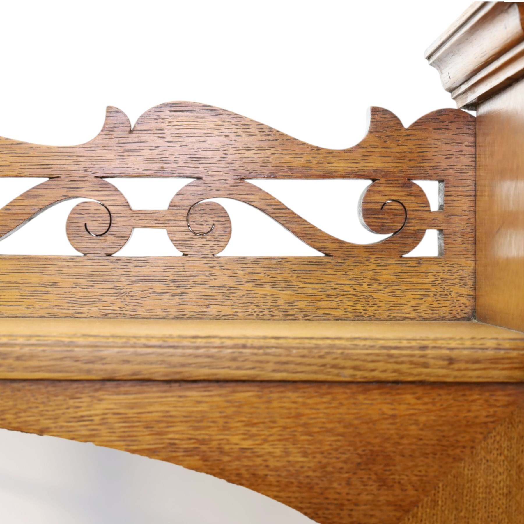 Maple & Co. - Arts & Crafts oak dresser with stained glass cupboard, raised section with pierced pediment above a mirrored back, with a stained glass fronted cupboard with fixed shelf, single long drawer, above a pair of fielded panels, with open recess above a short drawer, raised above a full length undertier with turned supports