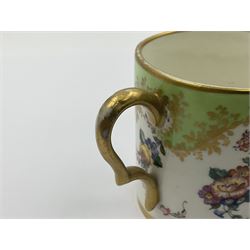 Sèvres soft paste porcelain coffee can and saucer with date code for 1754, painted and gilded with flowers, dangling from the shaped green border, interlaced LL monogram enclosing the date letter A above painters mark for Dodin, coffee can H7cm, saucer D14.5cm