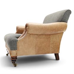 Tetrad - 'Taransay' Harris Tweed and tan leather club armchair, Howard shape with reclined back over deep seat and rolled arms with studwork, raised on turned front supports with castors, the sides and arms upholstered in tan leather with seat and back in herringbone-stitched Harris Tweed