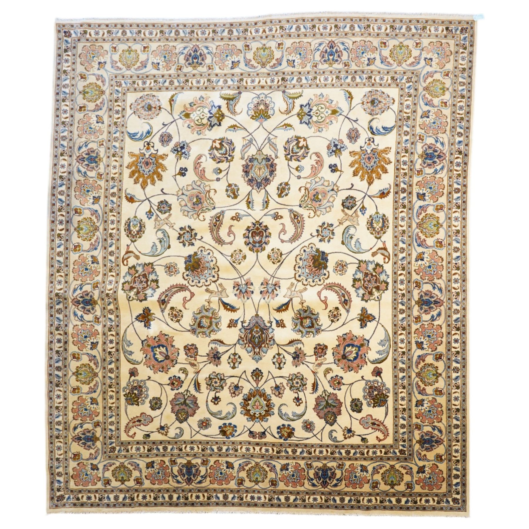 North East Persian Mashad hand-knotted carpet, ivory field decorated with an all-over scrolling floral vine design incorporating stylized palmettes, deer, rosettes and floral sprays enclosed by a conforming floral vine border between multiple guard stripes, cotton fringe ends