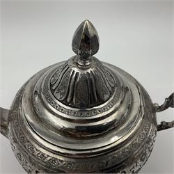 Early/mid 20th century Persian silver tea service, comprising circular serving tray, teapot, twin handled sucrier and cover, milk jug, five tea glasses with six silver holders, six tea spoons, and pair of sugar tongs, each profusely chased with foliate arabesque decoration, each bearing marks including 84 for 840 fineness, tray D40cm, teapot H16cm