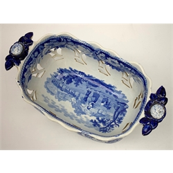 Mid 19th century blue and white transfer printed pearlware reticulated chestnut basket, of oval form with twin handles, decorated to the interior with figures before a classical temple within a garden setting, including handles W26cm, together with a mid 19th century blue and white transfer printed pearlware stand with reticulated edge, decorated with a Willow Pattern, L25cm, and a John and William Ridgeway blue and white transfer printed twin handled pierced basket, decorated with a pastoral scene containing figures at work, with printed mark beneath, including handles L25cm