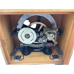 A mid-20th century Gent of Leicester(Blick Electric) Pulsynetic Master Clock in a full length glazed wooden case, with a square white dial with Arabic numerals, minute markers and baton hands, with pendulum and a record card dating from the 1970’s. 
This master clock would have been wired to send time signals to other slave dials in a large building, frequently used in hospitals, schools and factories during the 20th century
With a second electrical movement housed in a glazed square cabinet.


