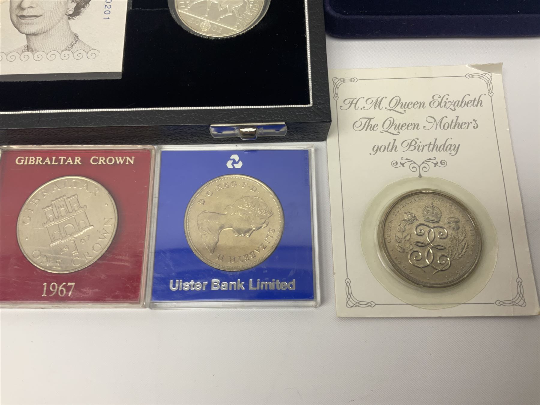 The Royal Mint United Kingdom 'Millennium' silver proof two coin set comprising 1999 and 2000 five pound coins, 2000 'The Queen Mother Centenary Year' silver proof crown, 2001silver proof one pound, 'Her Majesty The Queen Golden Jubilee 1952-2002' silver proof 2002 five pound coin and ten pound banknote set, all being cased with certificates, United Kingdom 1999 brilliant uncirculated coin collection in card folder, other commemorative coinage etc