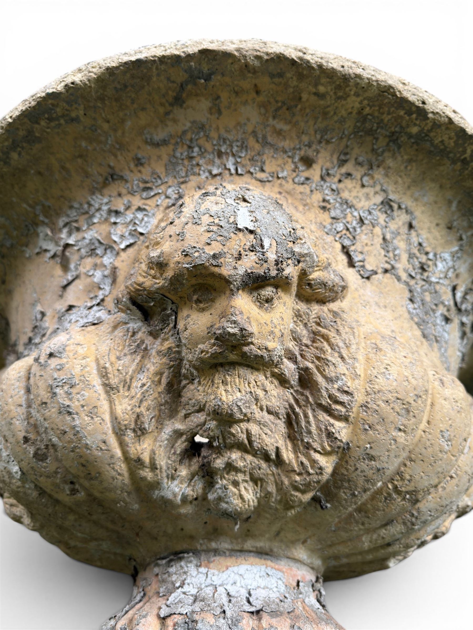 19th century terracotta campana shape urn planter, egg-and-dart moulded rim over a cherub-mask and gadrooned underbelly, turned pedestal and socle on square base