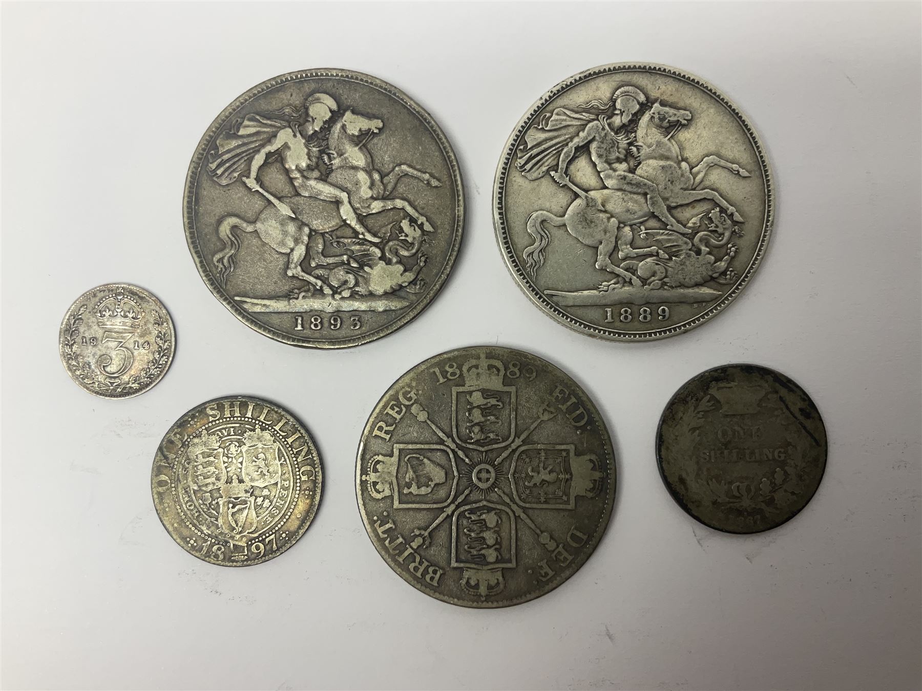 Two Queen Victoria silver crown coins dated 1889 and 1893, 1889 double florin, 1867 and 1897 one shilling, King George V 1914 threepence