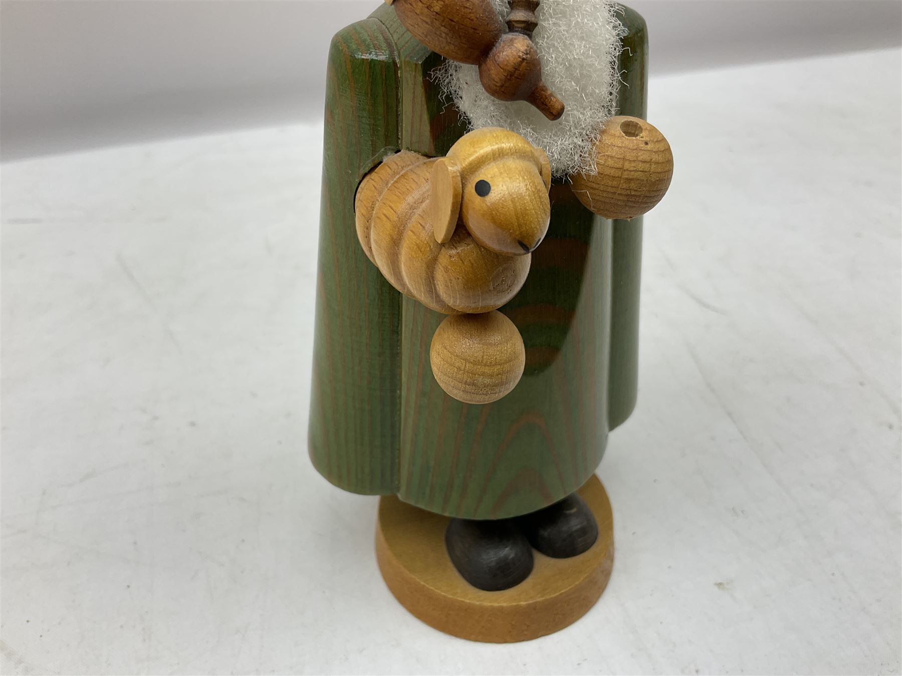 German Erzgebirgische Volkskunst folk art carved and stained wood smoking men incense burner figure, modelled smoking a pipe, with sticker label beneath, H19cm