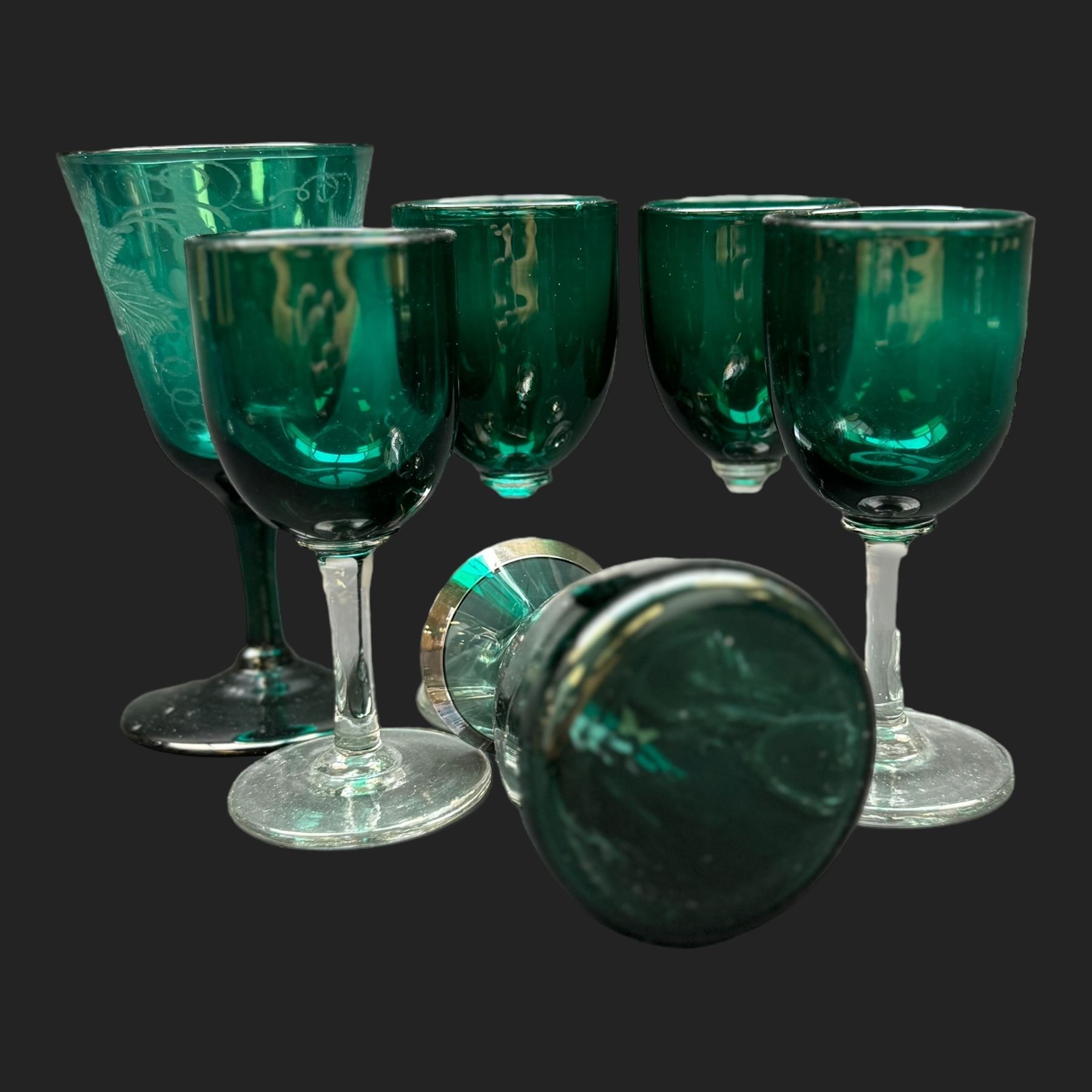 Pair of etched green glasses decorated with grapes and vine leaves, together with  blue glasses and other coloured glassware 