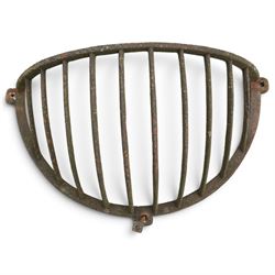 Victorian wrought iron wall-mounted stable hay rack of bowed cage form, with curved bars and fixing lugs