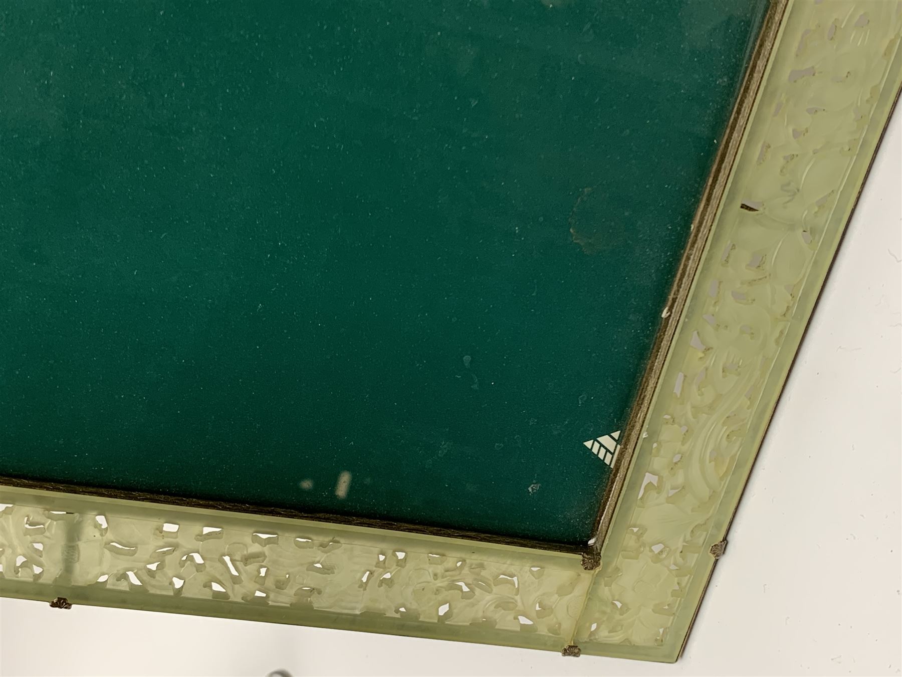 Early 20th century Chinese jade mounted photograph frame, of rectangular form the pierced jade frame carved with flowers and birds, the top panel carved with Foo dogs flaking an applied carved lavender coloured boss, with easel support verso, H33cm
