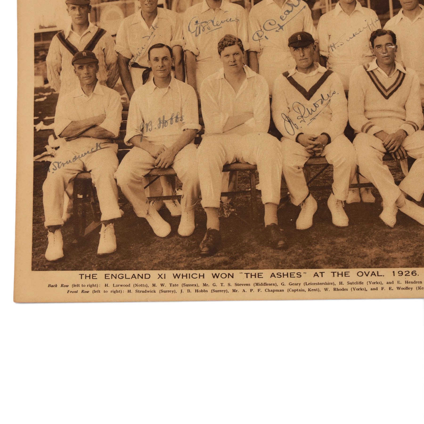 1920s All Sports Illustrated magazine page, depicting the 1926 Ashes winning England cricket team, signed by seven players including Maurice Tate, Greville Stevens, George Geary, Herbert Sutcliffe, Herbert Strudwick, Jack Hobbs and Wilfred Rhodes, mounted on card