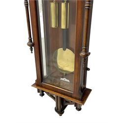 Lenzkirch – 8-day walnut cased weight driven Vienna regulator manufactured 1877-1878, with a break-arch pediment surmounted by a turned finial on a raised cavetto molding, fully glazed arched  door flanked by long ring turned pendants, flat base with open fretwork and two short pendants,  two piece enamel dial within a brass slip, Roman numerals, minute track and pierced steel hands, wooden pendulum with a brass faced bob, two brass cased weights and pulleys, dead beat escapement with a rack striking movement sounding the hours and half hours on a coiled gong, movement serial number 421410. 
Lenzkirch were one of Germanys most highly respected clock manufacturers of the 19th century, founded in the late 1850s the company produced movements and cases of high quality up until 1932.
