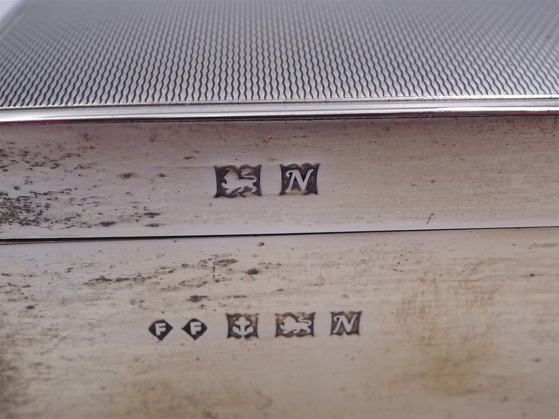 Modern silver mounted cigarette box, of rectangular form, with personal enraving to front and engine turned decoration and initials to cover, opening to reveal soft wood lined partitioned interior, hallmarked Frederick Field Ltd, Birmingham 1962