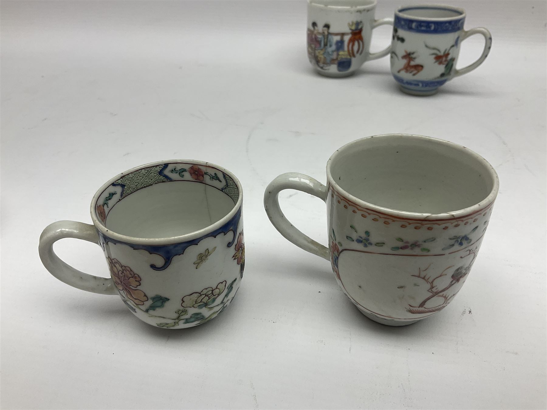 Two 18th century Chinese Yongzheng coffee cups, the first example decorated in polychrome enamel with rooster amidst blossoming peonies, the second decorated with deer and crane among rockwork and pine tree, together with two further 18th century Chinese coffee cups, an 18th century Chinese tea bowl, and a further tea bowl