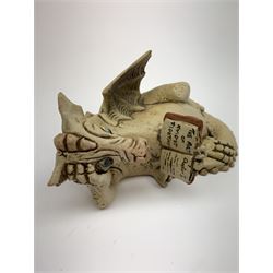 Zell Osbourne (British, Contemporary), Bookworm, a Studio Pottery figure modelled as a recumbent dragon with book, L21cm. 