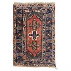 Caucasian Kazak rug, red field with three bold geometric medallions in dark blue, cream an...