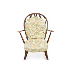 Ercol - Mid-20th century ‘Fleur-de-Lis’ rocking chair, elm and beech frame with curved arms, pierced back crest and stick supports, floral upholstered seat and back cushions, on curved rockers
