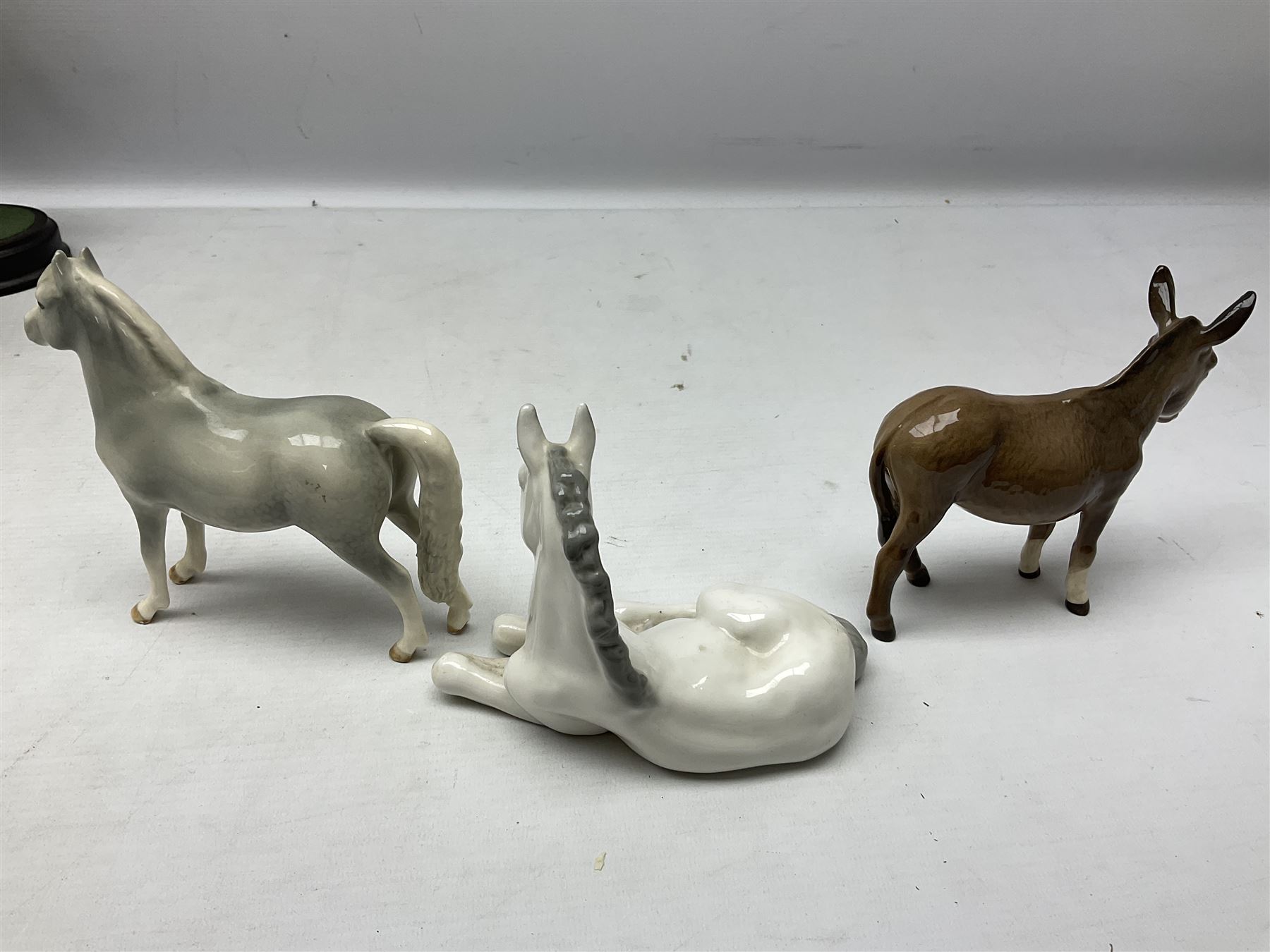 Collection of Beswick horse figures, to include Red Rum on a wooden plinth,  Lammtarra on oval plinth, Morgan Horse Black and three others, together with Royal Daulton Appaloosa Foal and a USSR horse