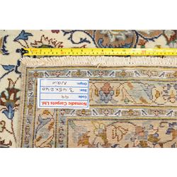 Central Persian Nain hand-knotted carpet, ivory field with central radiating medallion with pendants, issuing an all-over design of scrolling vines, palmettes, and floral sprays within confirming spandrels, framed a complimentary foliate border flanked by multiple guard stripes, with cotton fringe ends 