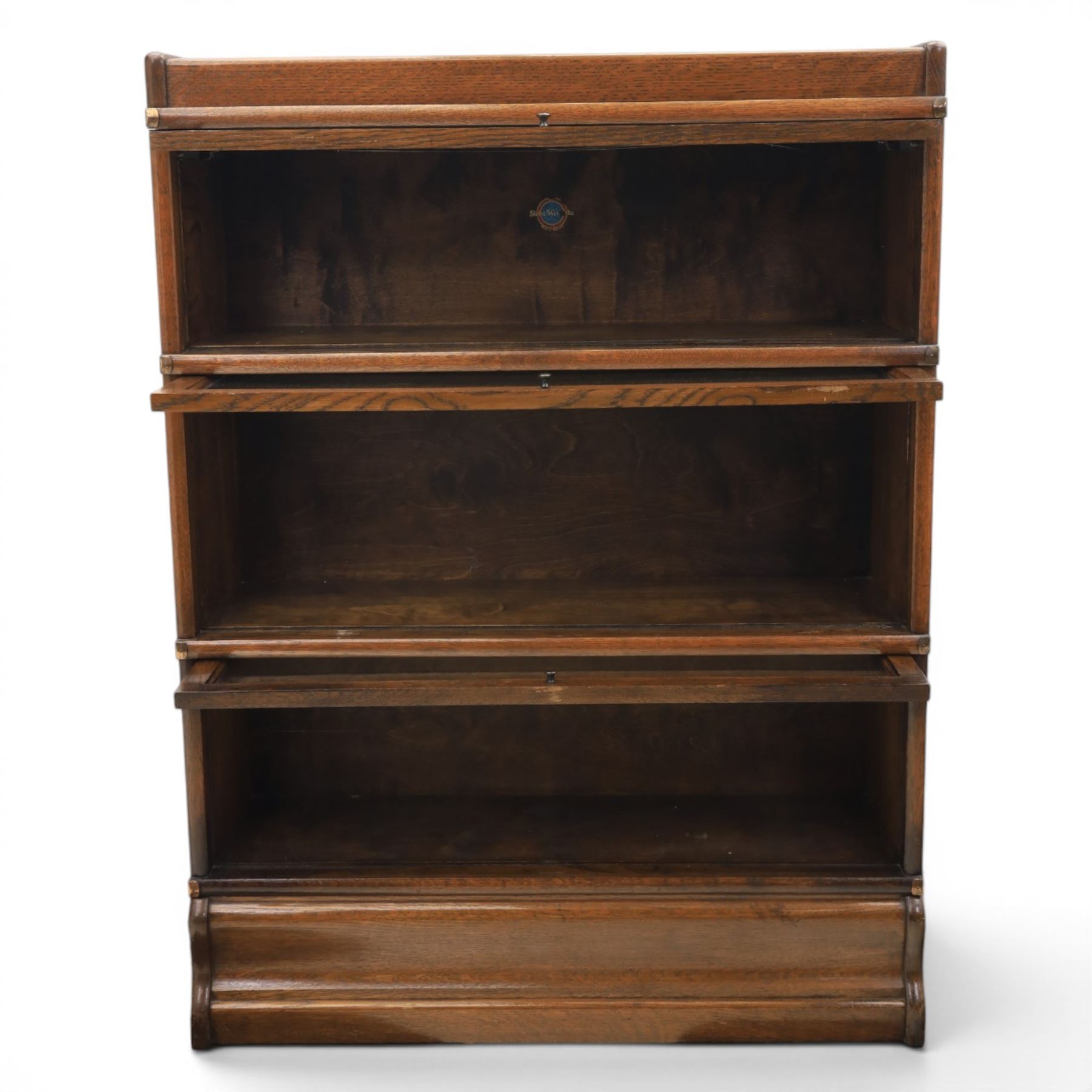 Globe Wernicke - early 20th century oak stacking bookcase, three tiers, lift up glazed doors raised on a plinth base
