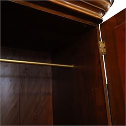 Victorian figured walnut double wardrobe, projecting moulded cornice over twin arched silvered mirrored doors, fitted with hanging rail and drawer with campaign style handle, on plinth base