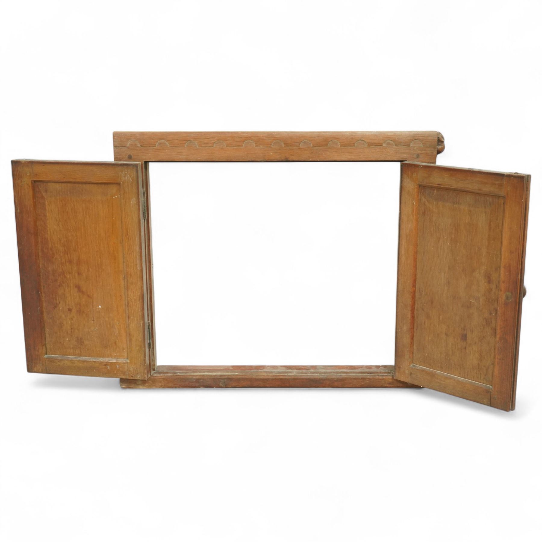 Mouseman - oak cupboard fascia or hatch, of rectangular form with twin panelled doors, circular hinges, raised on plinth, with carved mouse signature, by the workshop of Robert Thompson, Kilburn