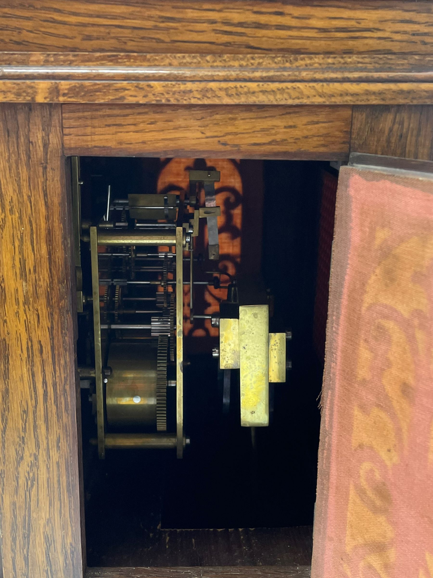 Winterhalder & Hofmeier- German 8-day oak cased mantle clock, in an architectural styled case with a gable pediment and recessed carving to the tympanum, square brass dial flanked by carved reeded pilasters and capitals, with open carved silk backed sound frets on a shaped plinth with padded feet, brass dial with cast spandrels and silvered chapter, Roman numerals, minute track and stylised gothic hands, conforming chime/silent and pendulum regulation dials, twin train going barrel movement with quarter-hour striking on two coiled gongs and the hours on one.
With pendulum.